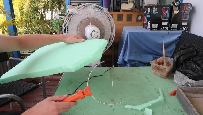 Use a hot wire foam cutter to carve and shape the foam, creating a natural-looking curvature.