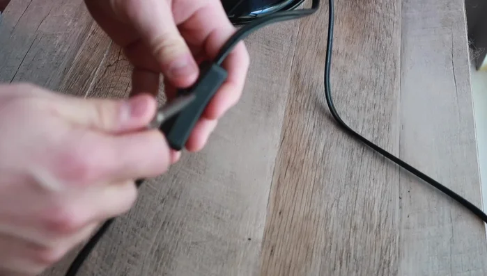 Carefully open the dome light housing by finding the seams and gently prying it open. Be cautious not to cut the wires.