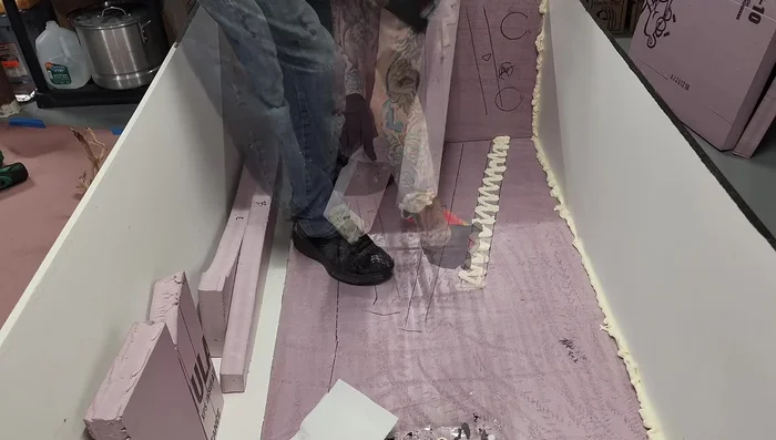 Spray foam the bottom seam and dampen with water to help cure.