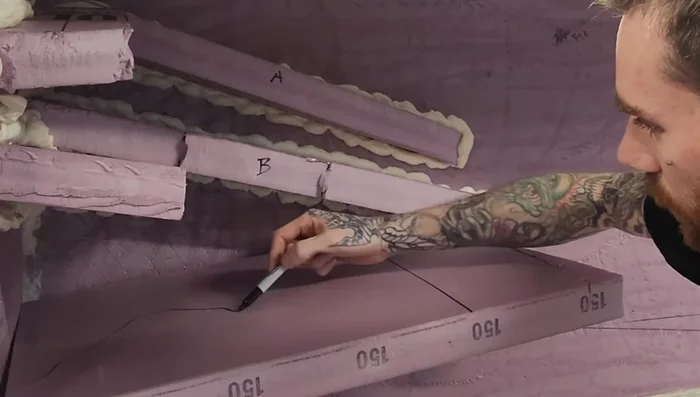 Remove excess spray foam once cured and carve ledges for detail.