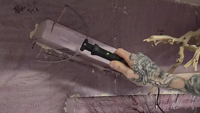 Remove excess spray foam once cured and carve ledges for detail.