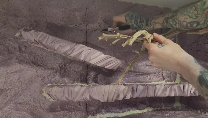 Add extra ledges with spray foam and carve them down after curing.