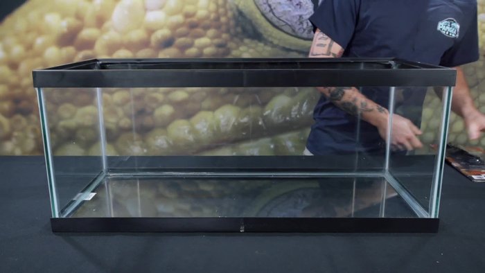 Attach the feet to the corners of the tank to lift it and allow the cord to fit underneath.