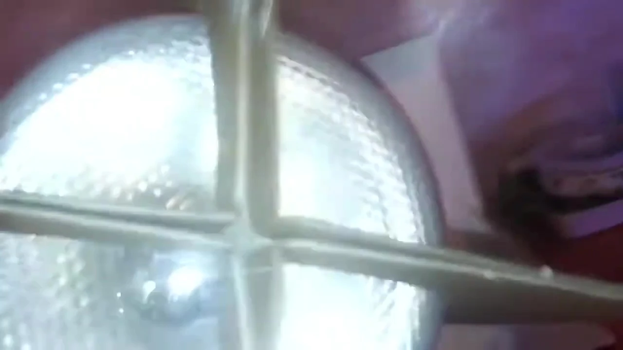 The lamp is examined, the speaker points at the socket to demonstrate there's no damage