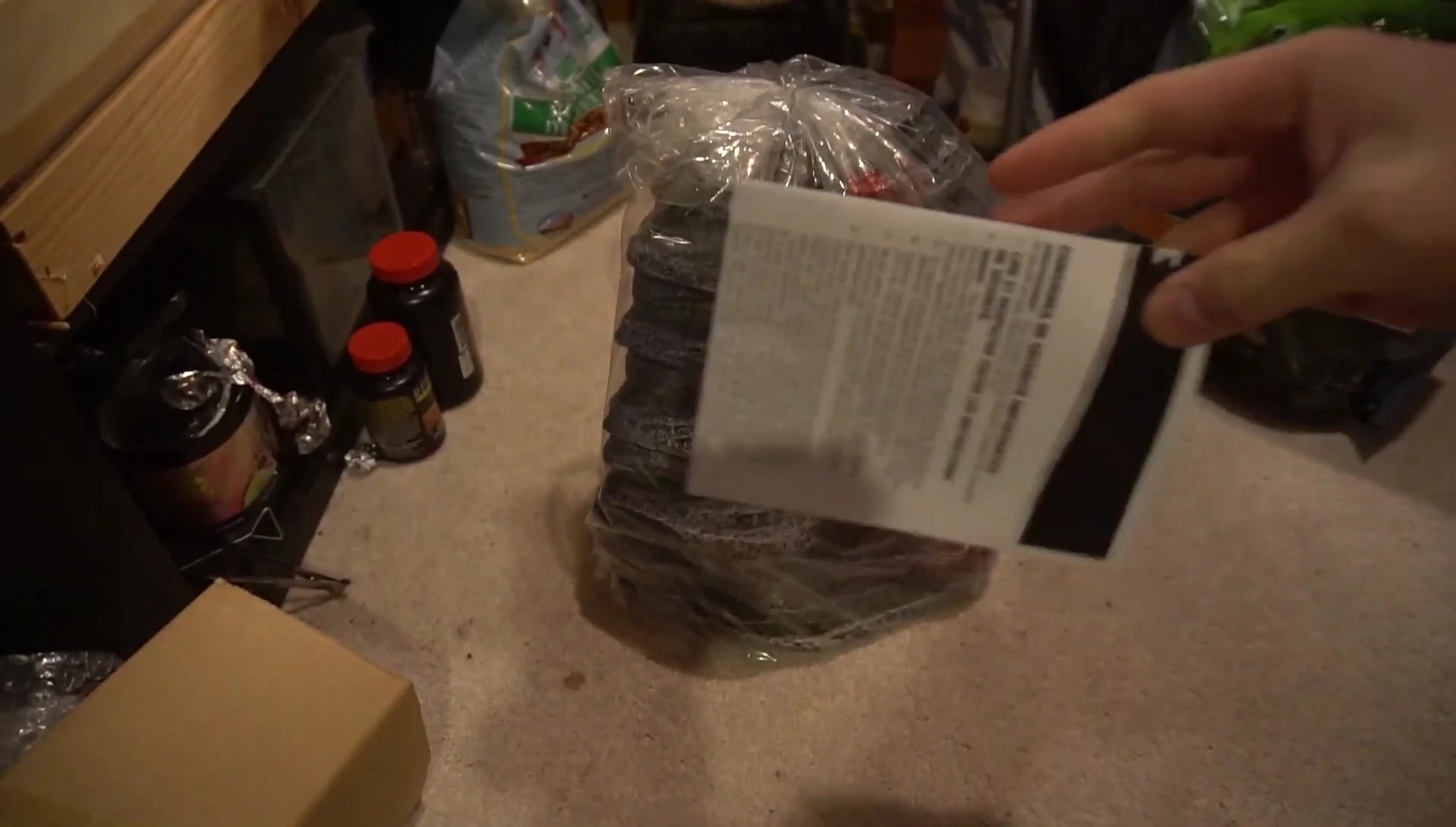 The reviewer struggling to open the sturdy packaging