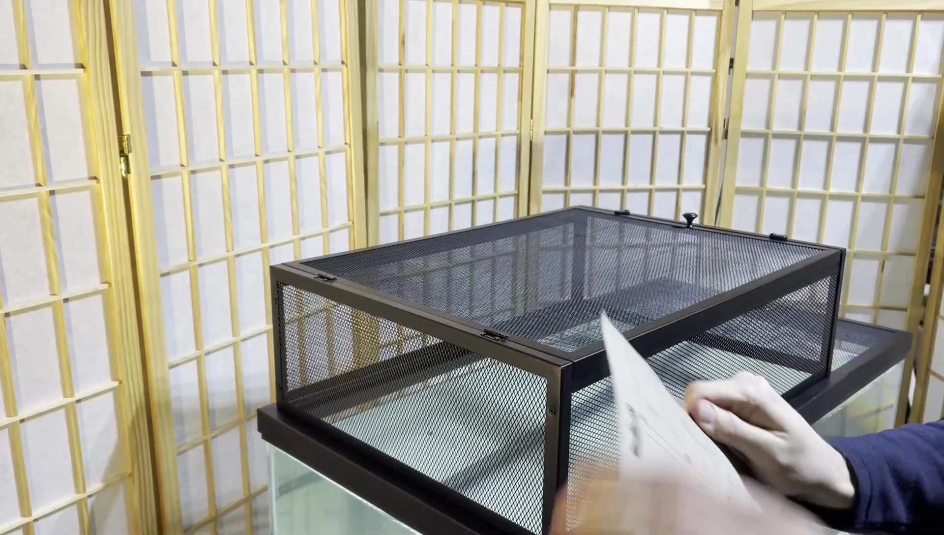 Attaching the light bracket to the basking loft using zip ties.