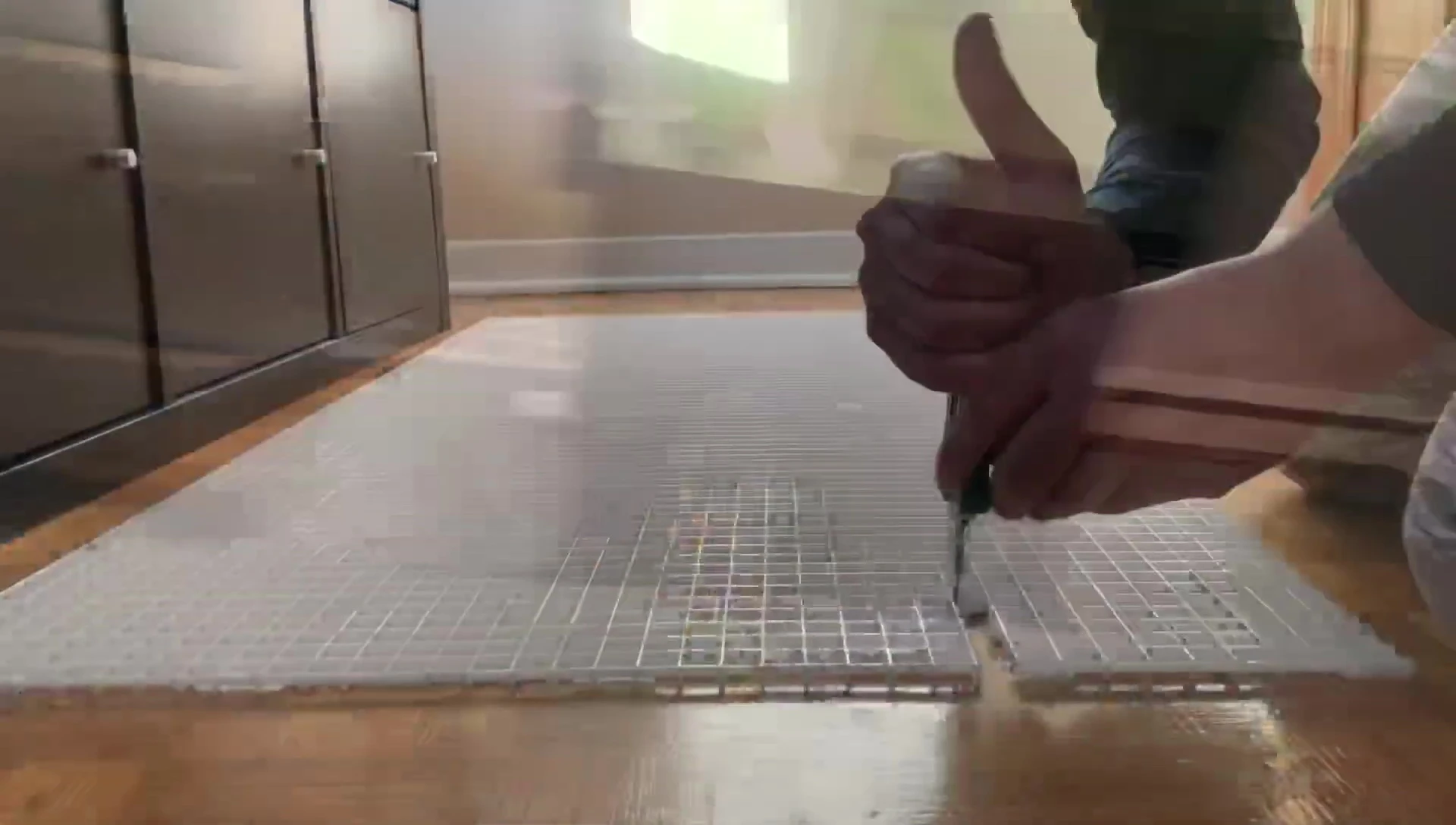 Moving to a different area to cut the plastic.