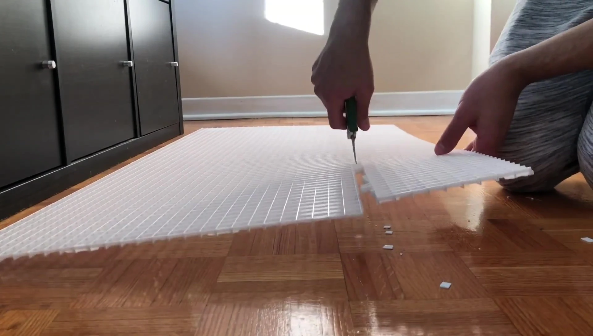 Using sharp scissors to cut the plastic.