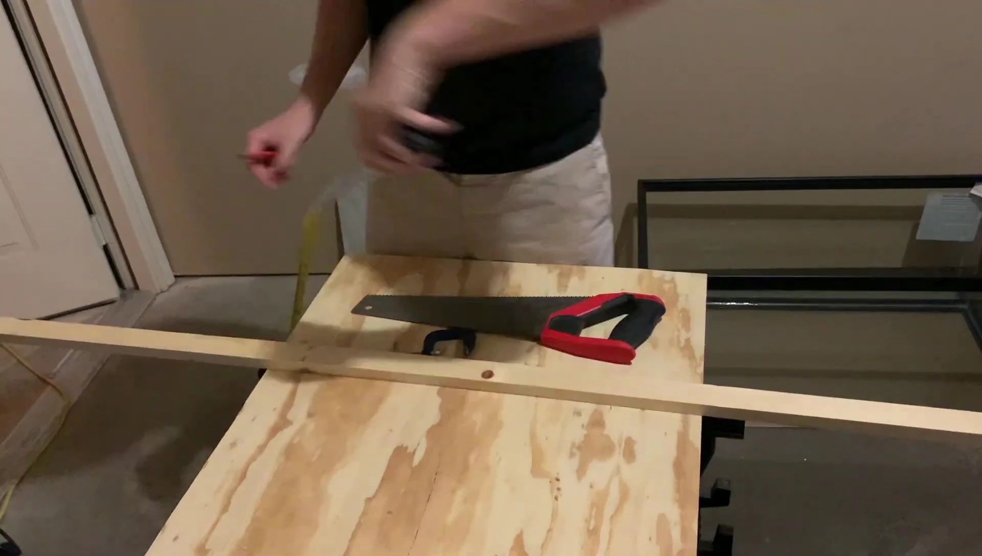 Cutting the white wood board.