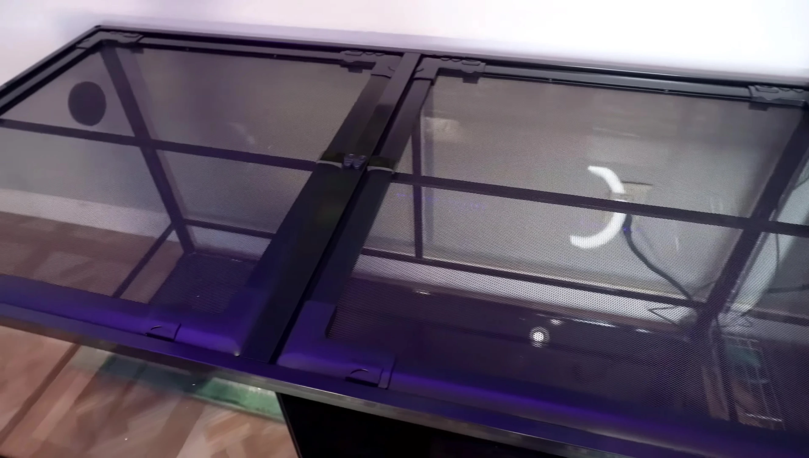 The mesh top of the enclosure.