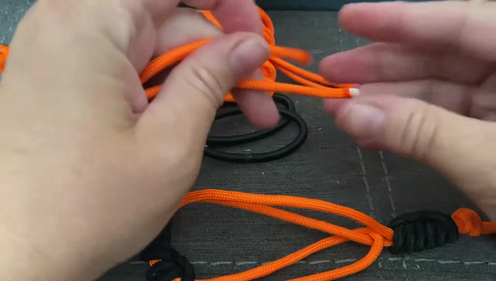 Melting the ends of the paracord with a lighter.
