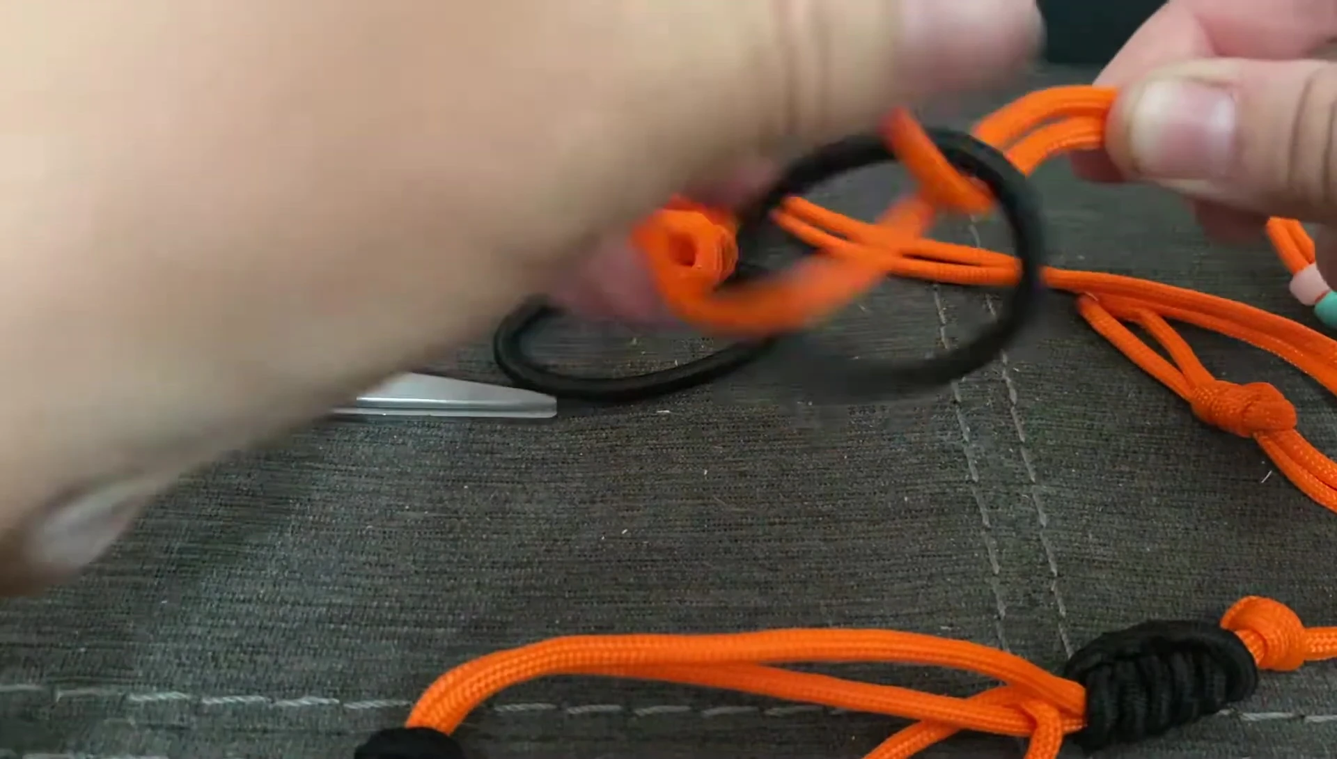 Wrapping a hair elastic around the paracord.