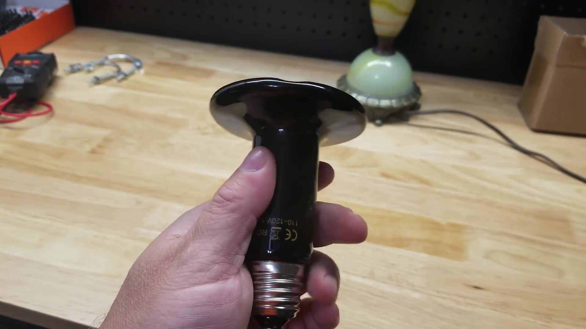 Close-up of the ceramic heat emitter bulb in its packaging.