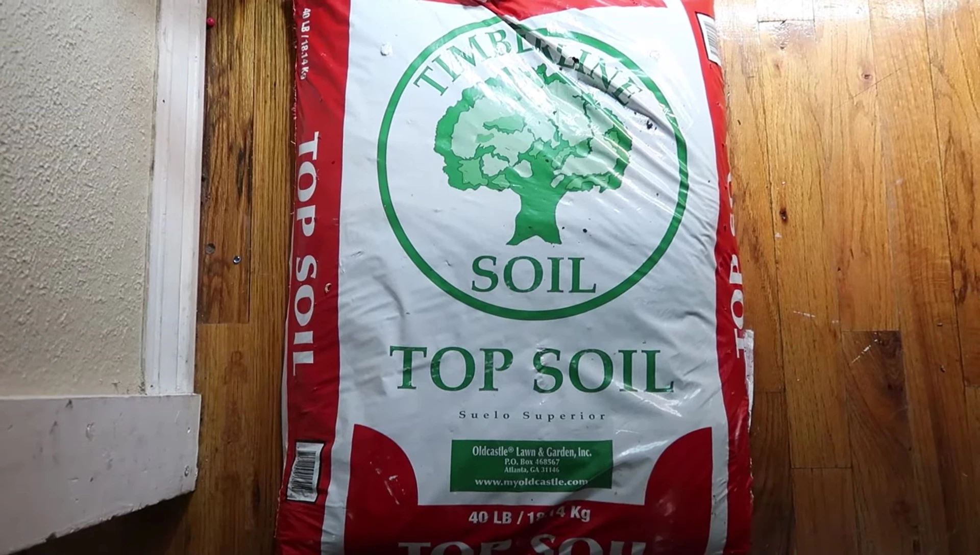 Speaker showing a bag of Timberline topsoil.
