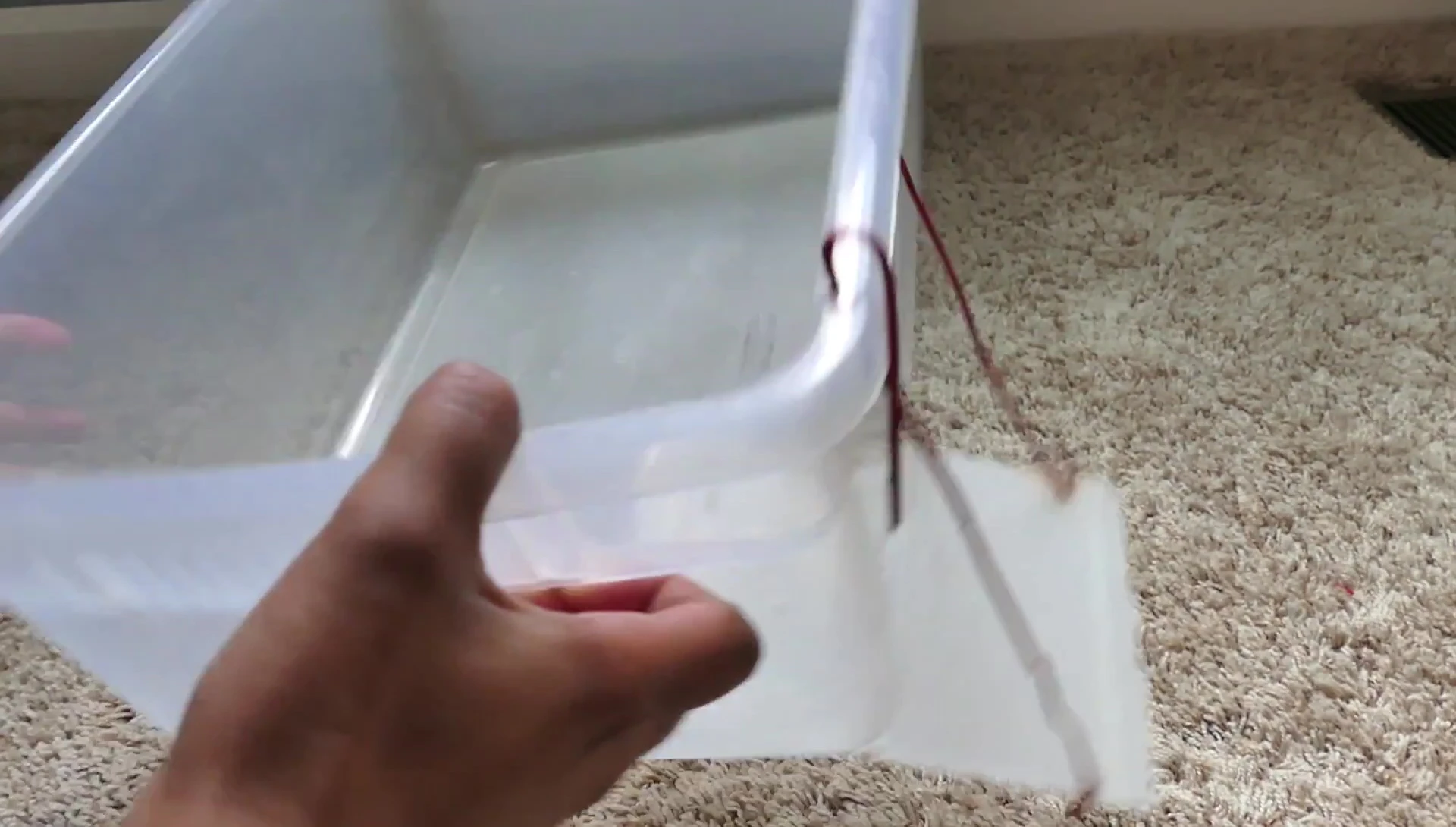 Cutting the hole in the plastic bin.