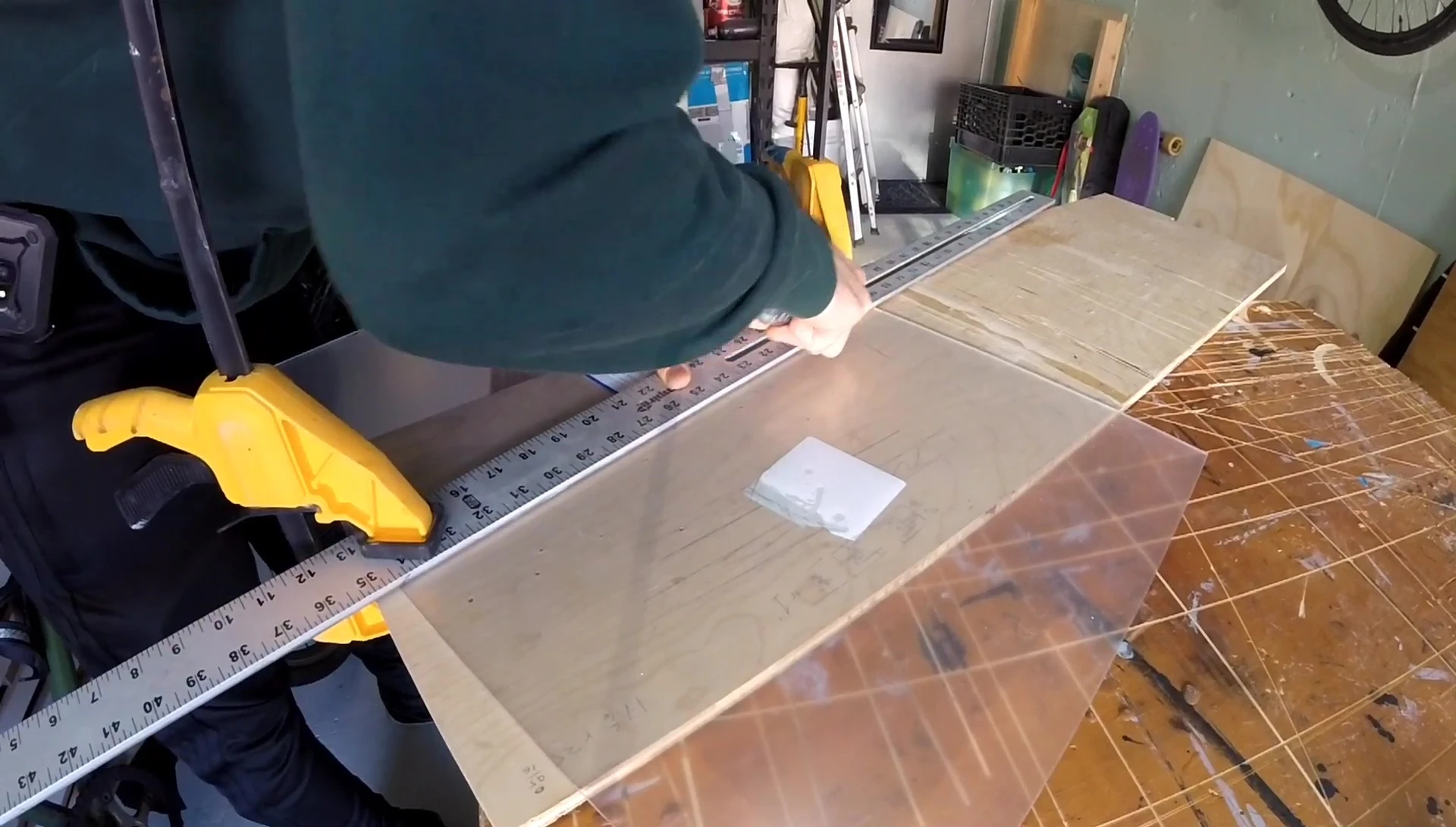 Close-up of cutting plexiglass with a utility knife.