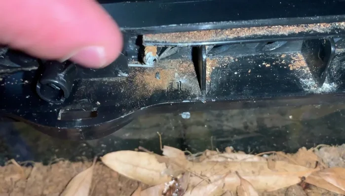 Attach the second ring on the spring to the screw beside the lock.