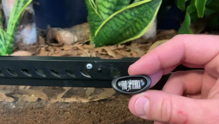 Attach the second ring on the spring to the screw beside the lock.