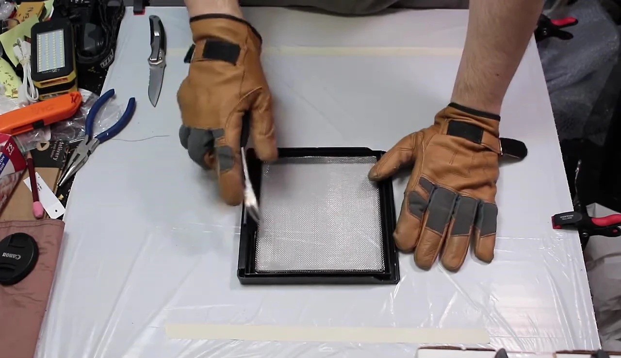 Removing the gasket with a knife and pliers.