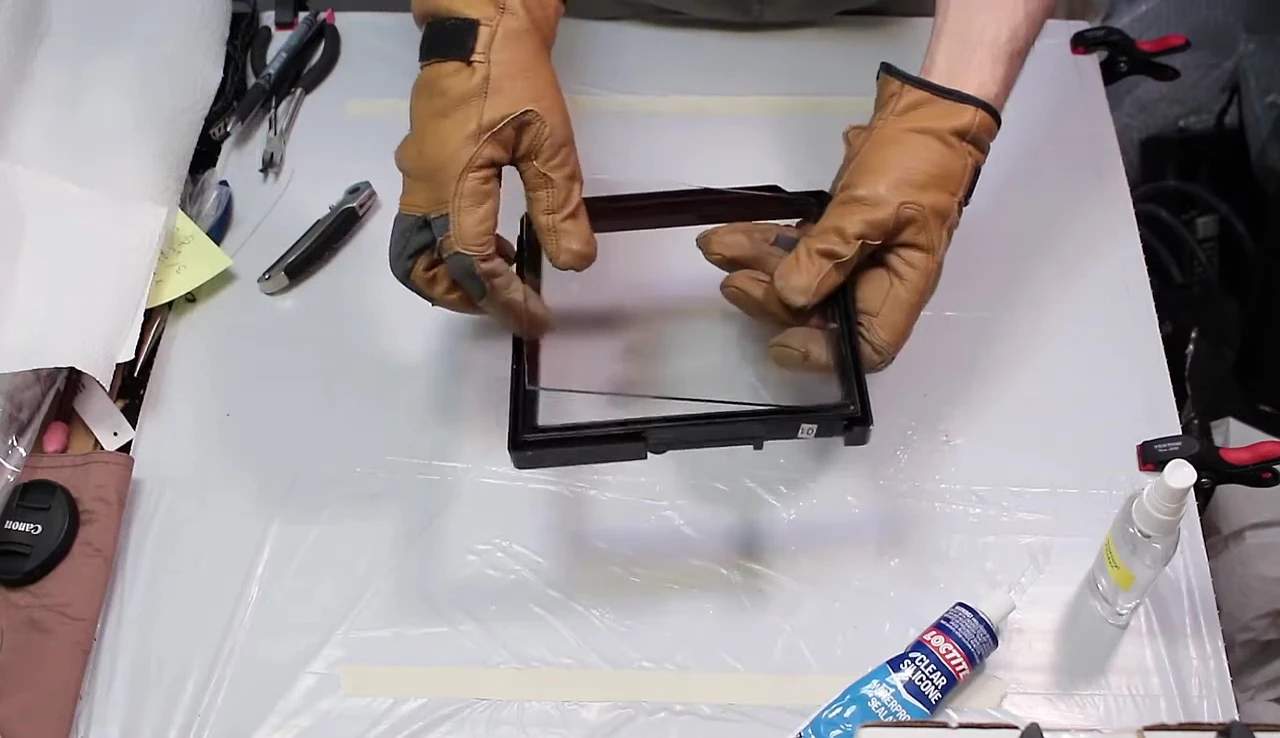 Test-fitting the glass panel into the frame.
