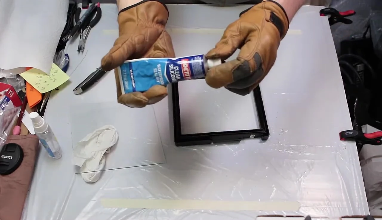 Applying silicone sealant to the frame.