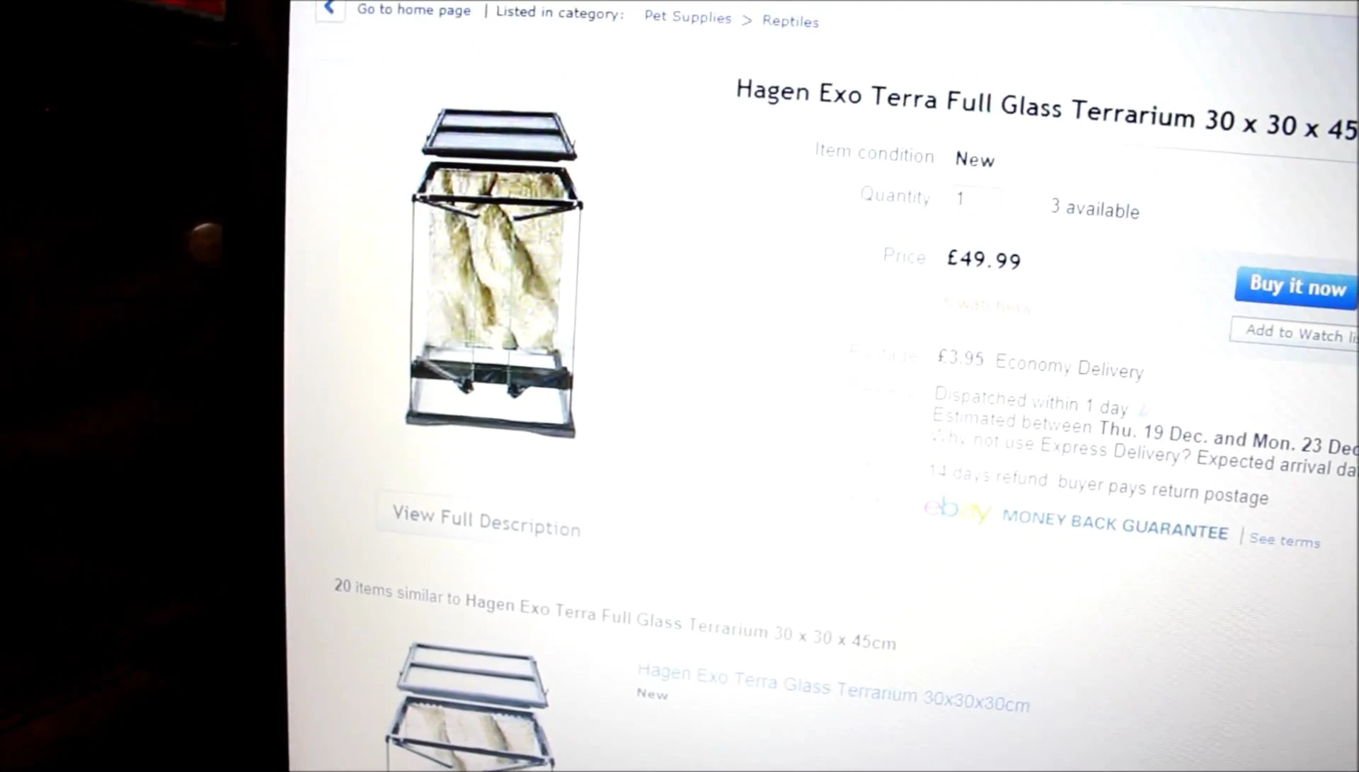A glass terrarium with the speaker pointing out its features