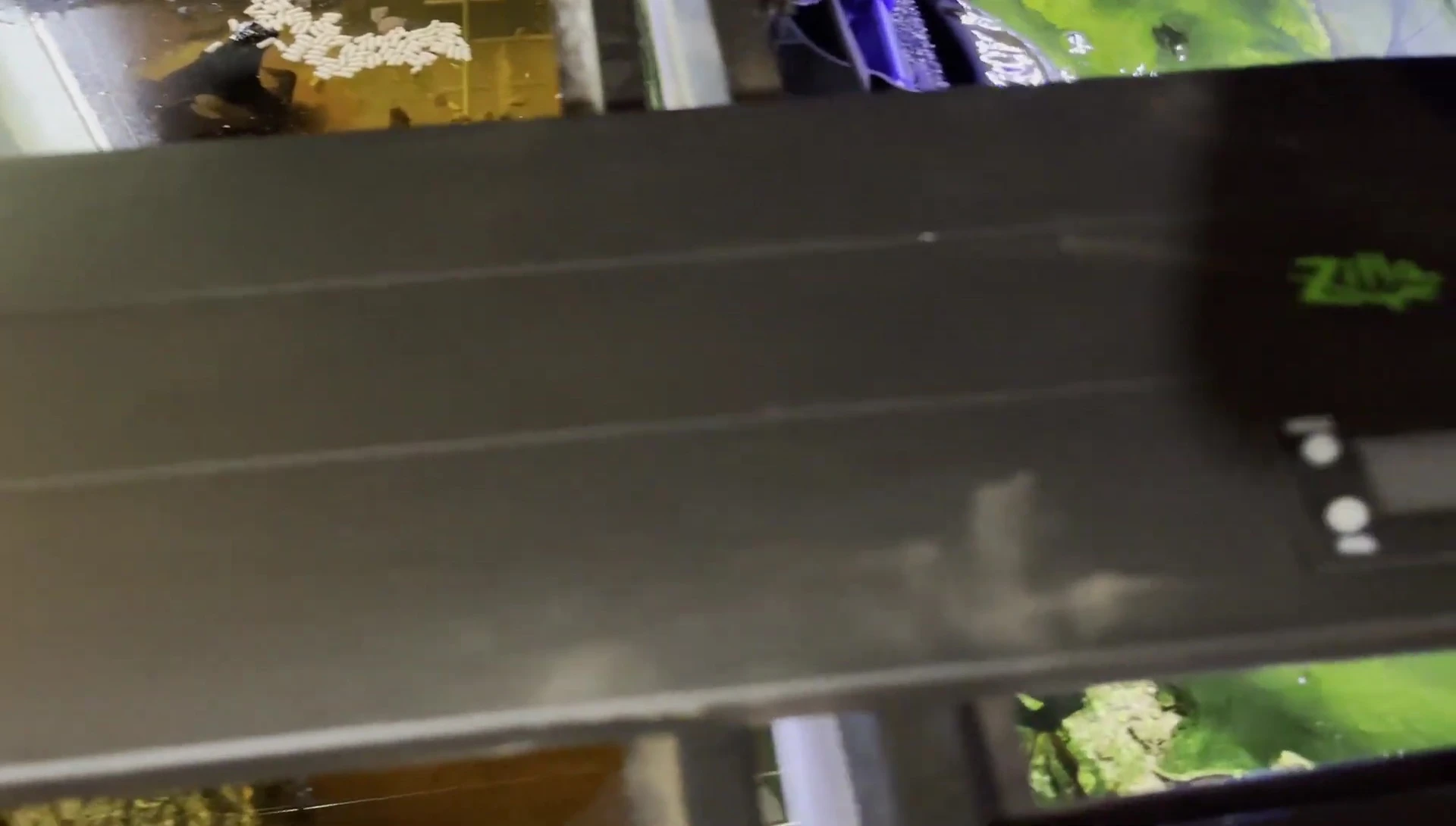 The fixture positioned on top of a reptile enclosure.