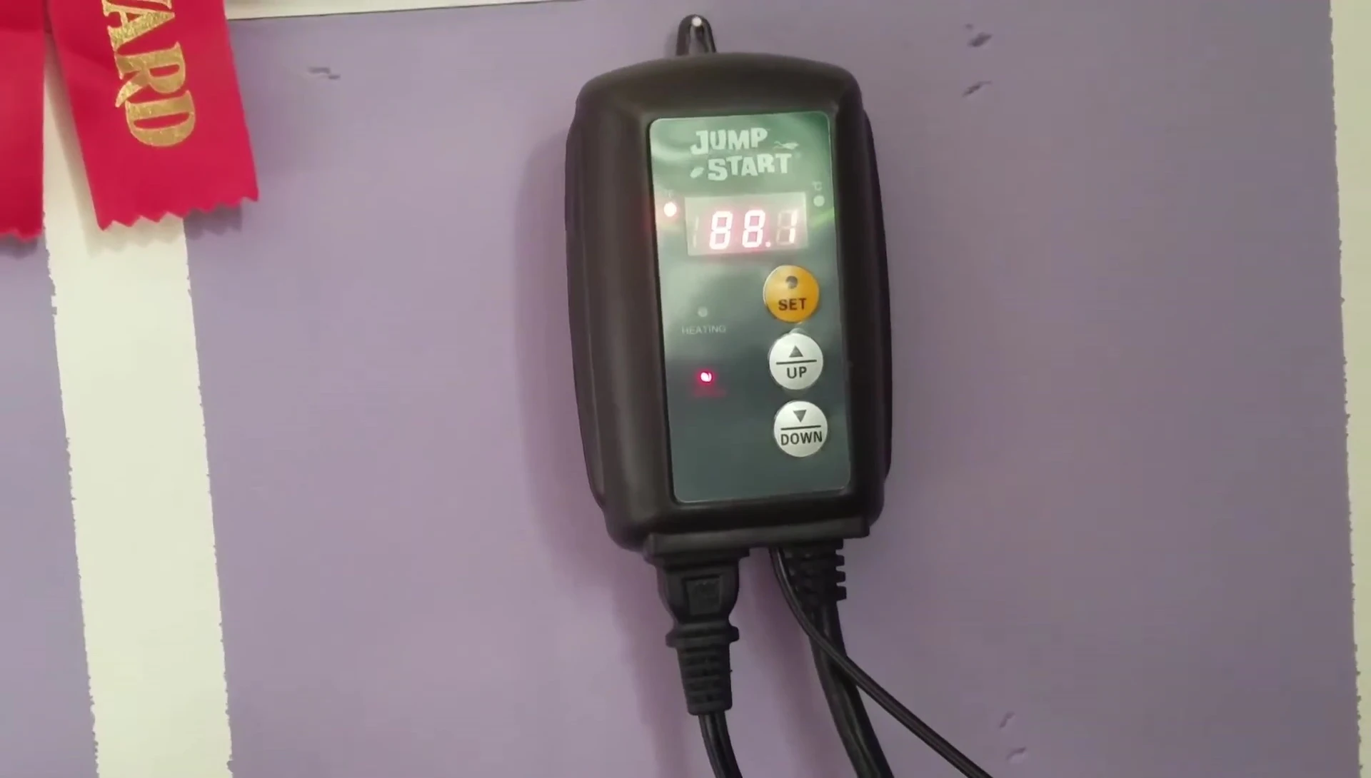 Close-up of the JumpStart Thermostat showing the display and buttons