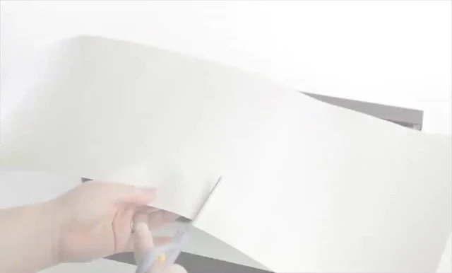 Using scissors to cut the HabitatWraps cling.