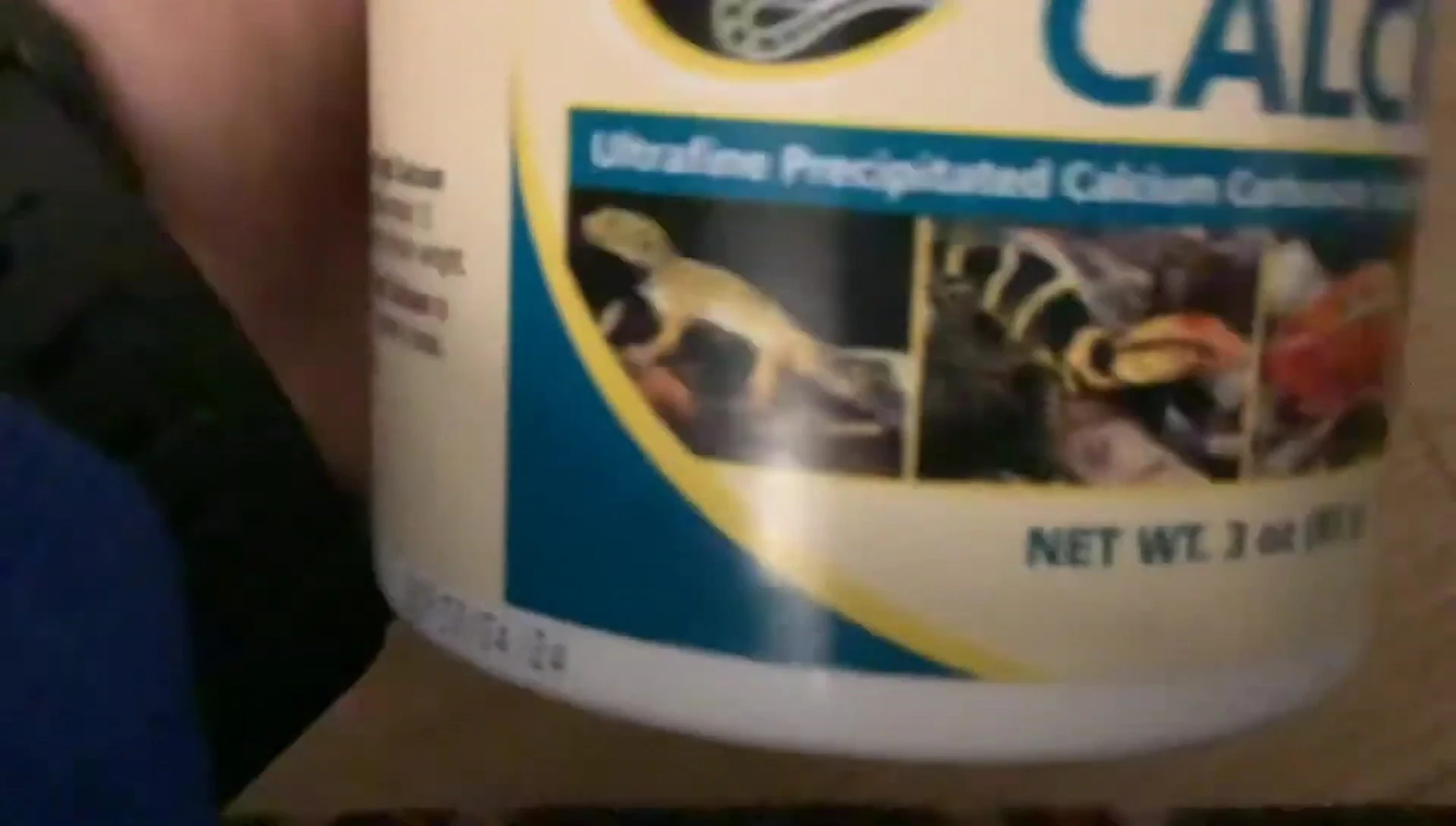 Close-up of the product packaging showing pictures of reptiles.