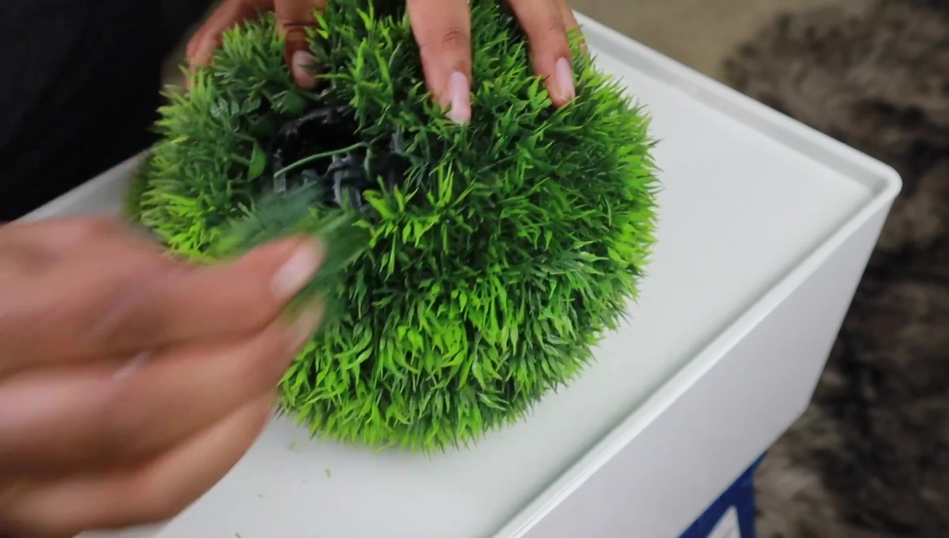 The process of removing some of the decorative flowers to better access the inner netting.