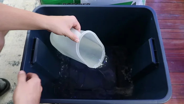 Add an entire gallon of water to your mixing tub. This rehydrates the peat moss.