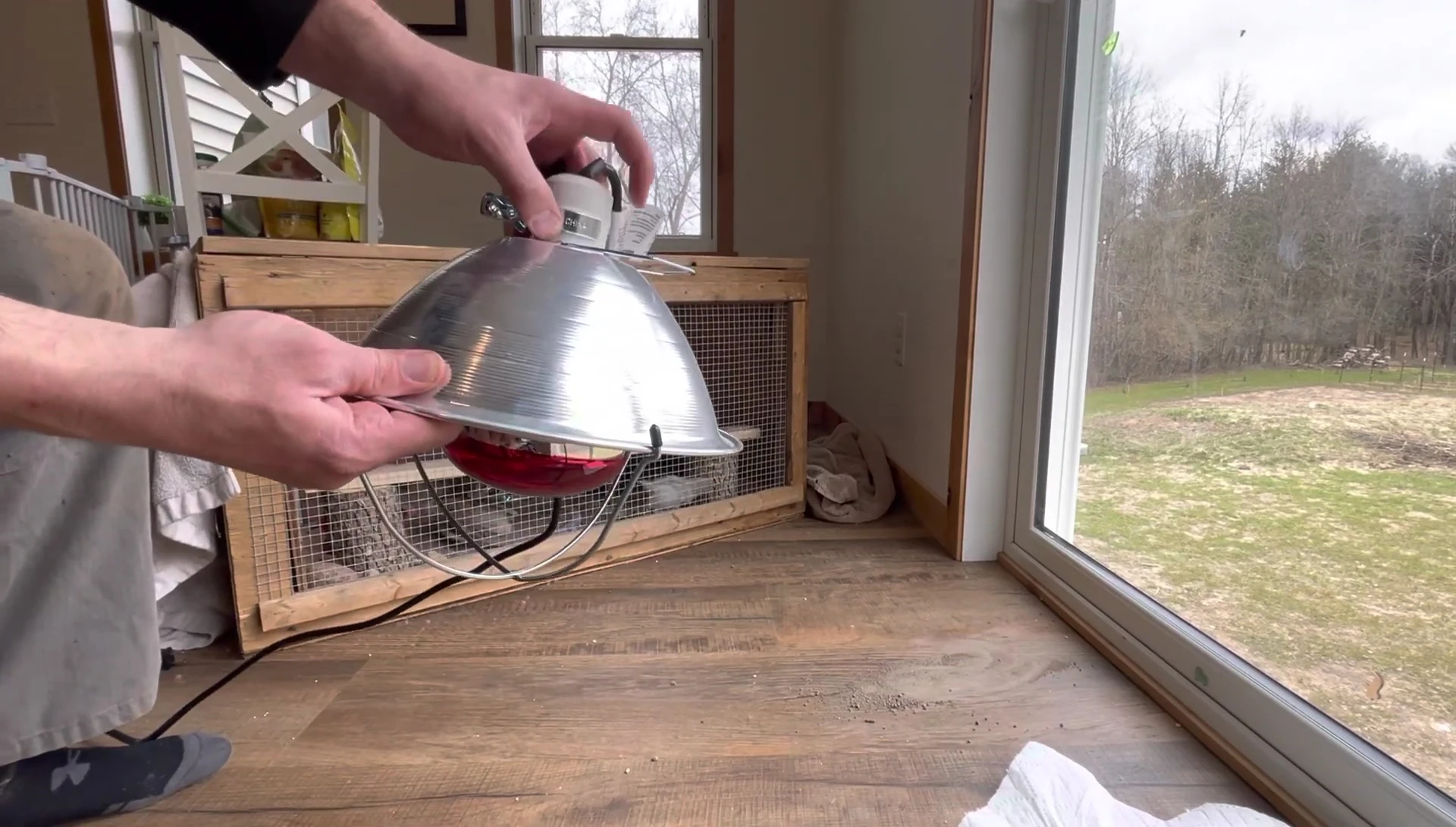 The clamp being positioned around the heat lamp.