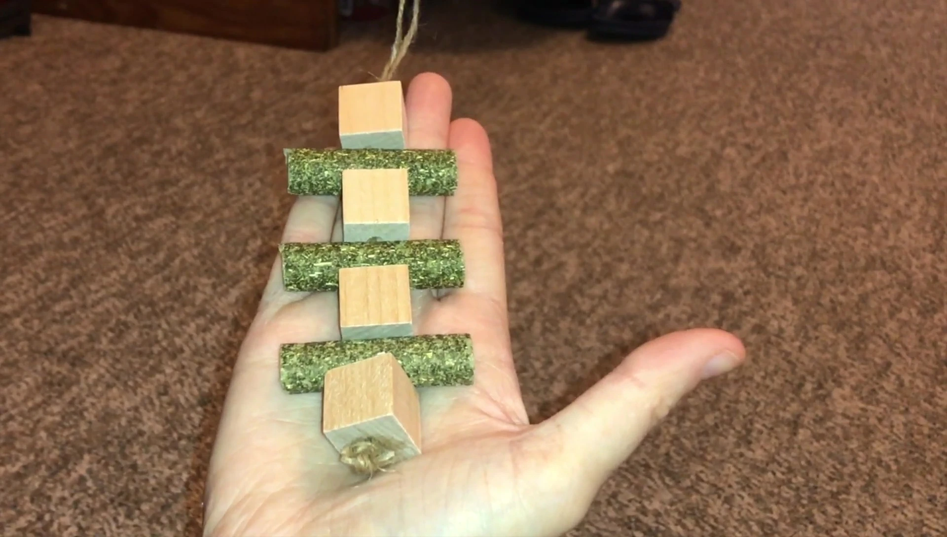 The kebab toy with sisal string, wooden blocks, and hay pellets