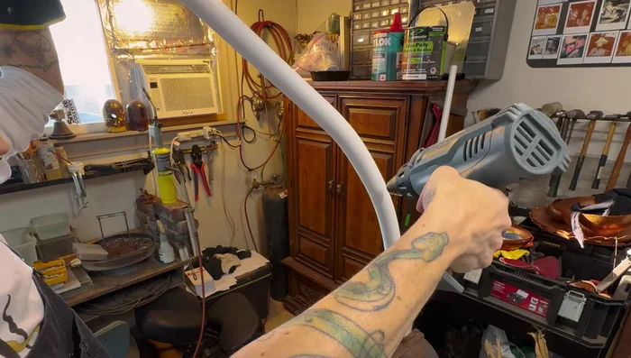 Shape PVC branches: Use a heat gun to make bends in the PVC pipes. Attach a second identical fitting to a 4x6 as a jig for easier work.