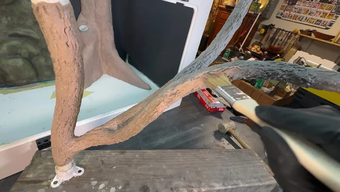 Paint branches: Apply a base coat, then washes of darker colors into crevices, followed by dry brushing of lighter colors. Match the colors of branches to their trunk for a cohesive look.