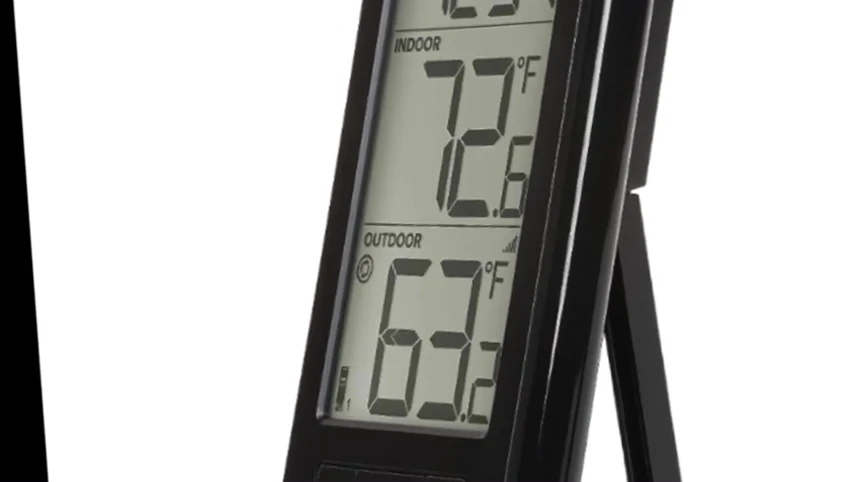 The La Crosse Technology thermometer displaying both indoor and outdoor temperatures and humidity.