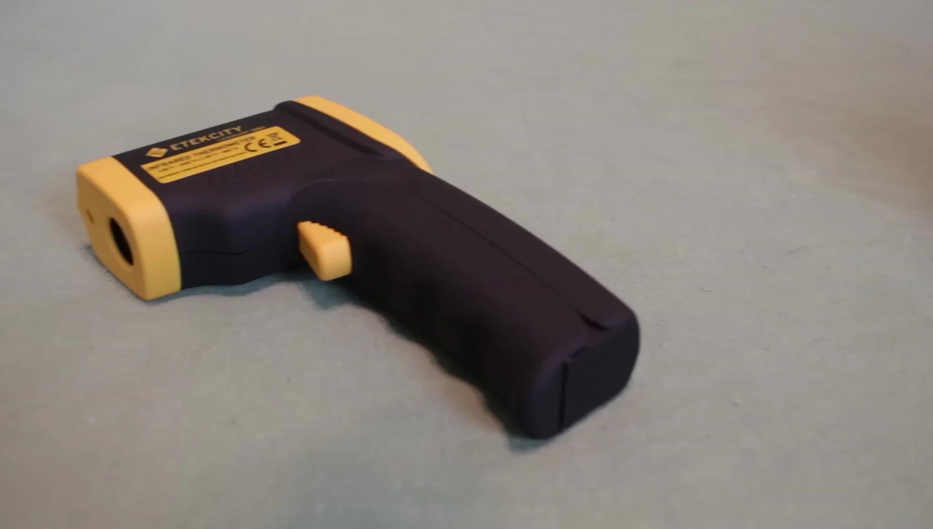 Close-up of an infrared thermometer being used to measure temperature.