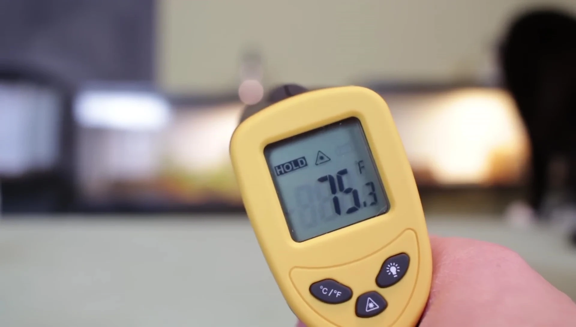 The infrared thermometer displaying a temperature reading.